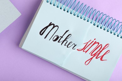 Notebook with words Single Mother on violet background, top view