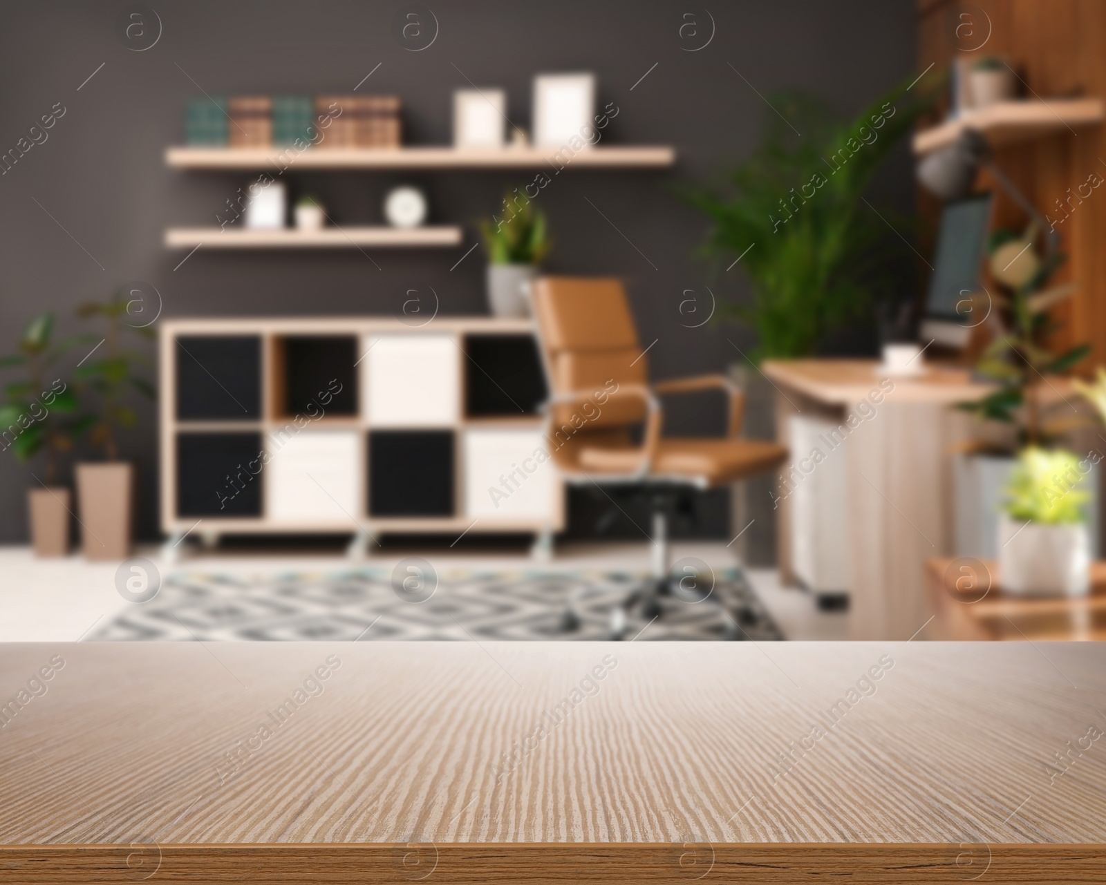 Image of Empty wooden surface and blurred view of modern office interior, closeup. Space for text 