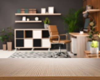 Image of Empty wooden surface and blurred view of modern office interior, closeup. Space for text 