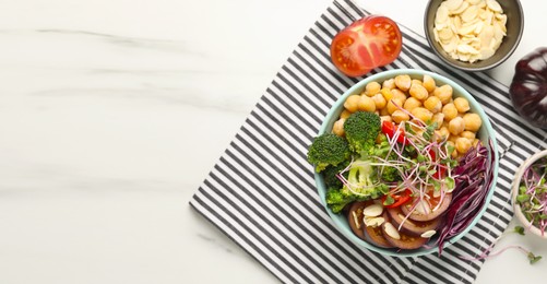 Image of Delicious vegan bowl with broccoli, red cabbage and chickpea on white marble table, flat lay. Banner design with and space for text