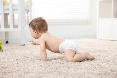 Baby boy crawling on carpet at home