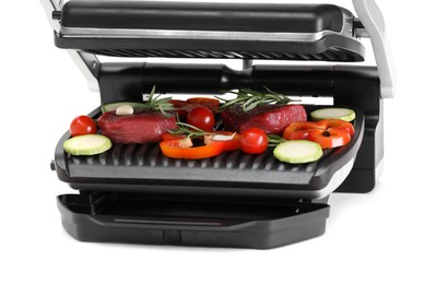 Electric grill with raw meat, rosemary and vegetables isolated on white