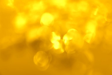 Image of Blurred view of shiny golden lights as background. Bokeh effect