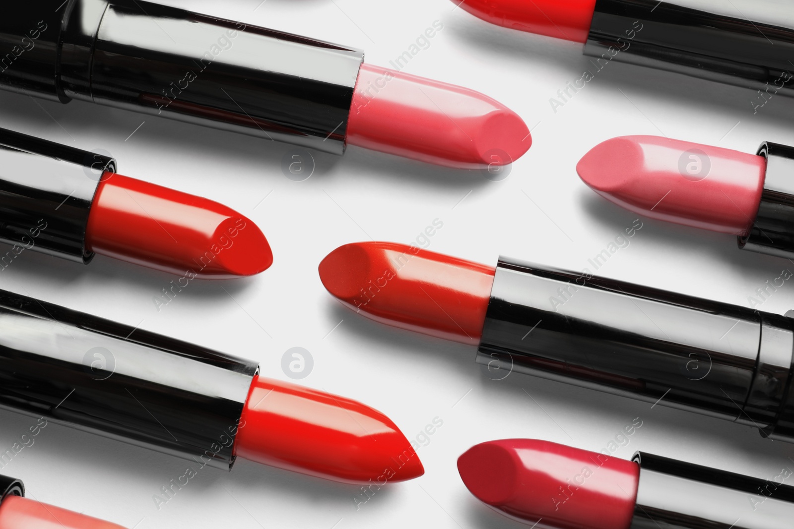 Photo of Flat lay composition with lipsticks on white background