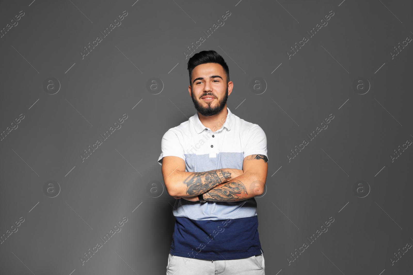 Photo of Portrait of handsome young man on gray background