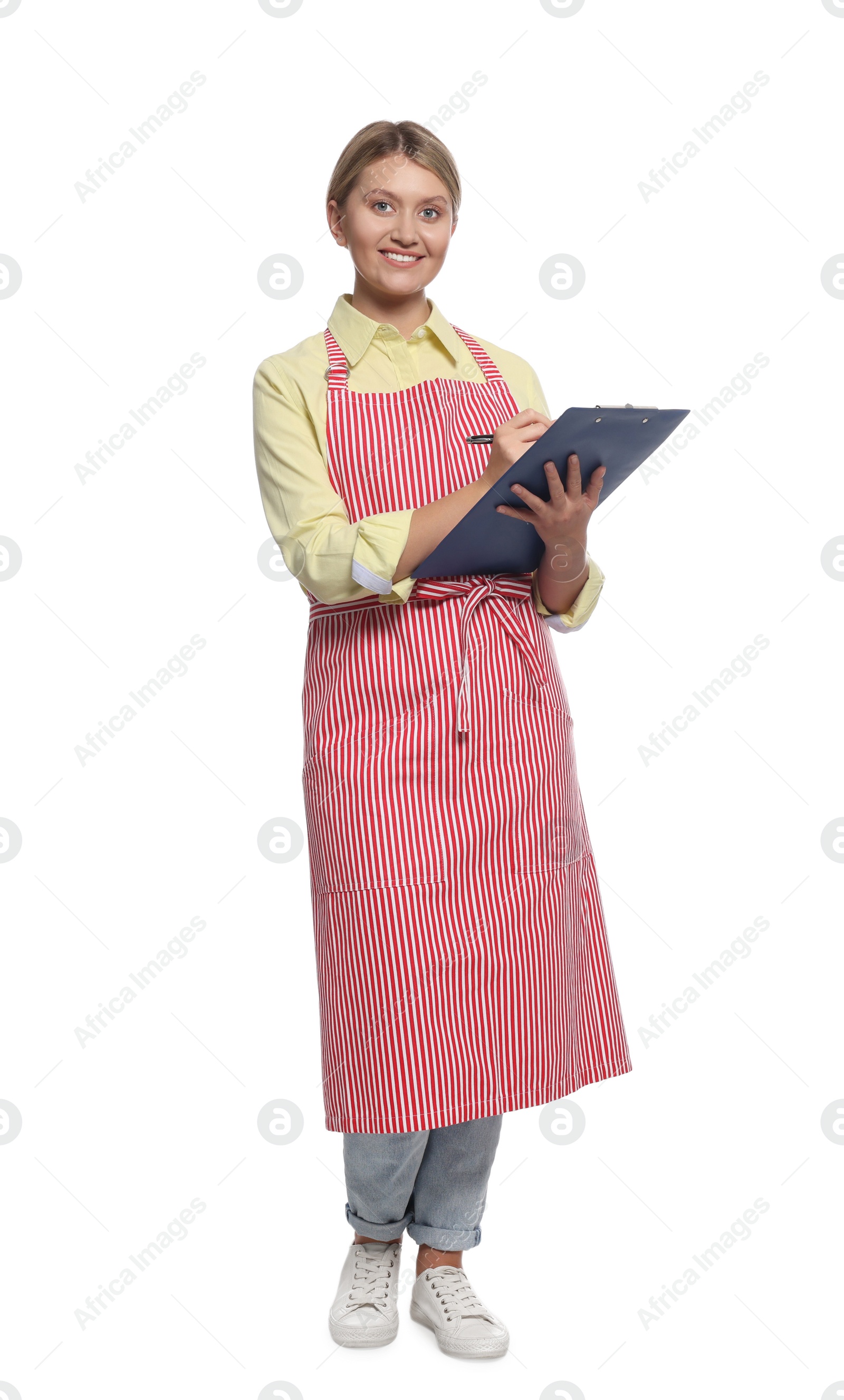 Photo of Beautiful young woman in clean striped apron with clipboard on white background