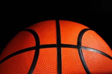 One basketball ball on black background, closeup
