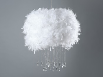 Stylish modern lamp hanging on grey background