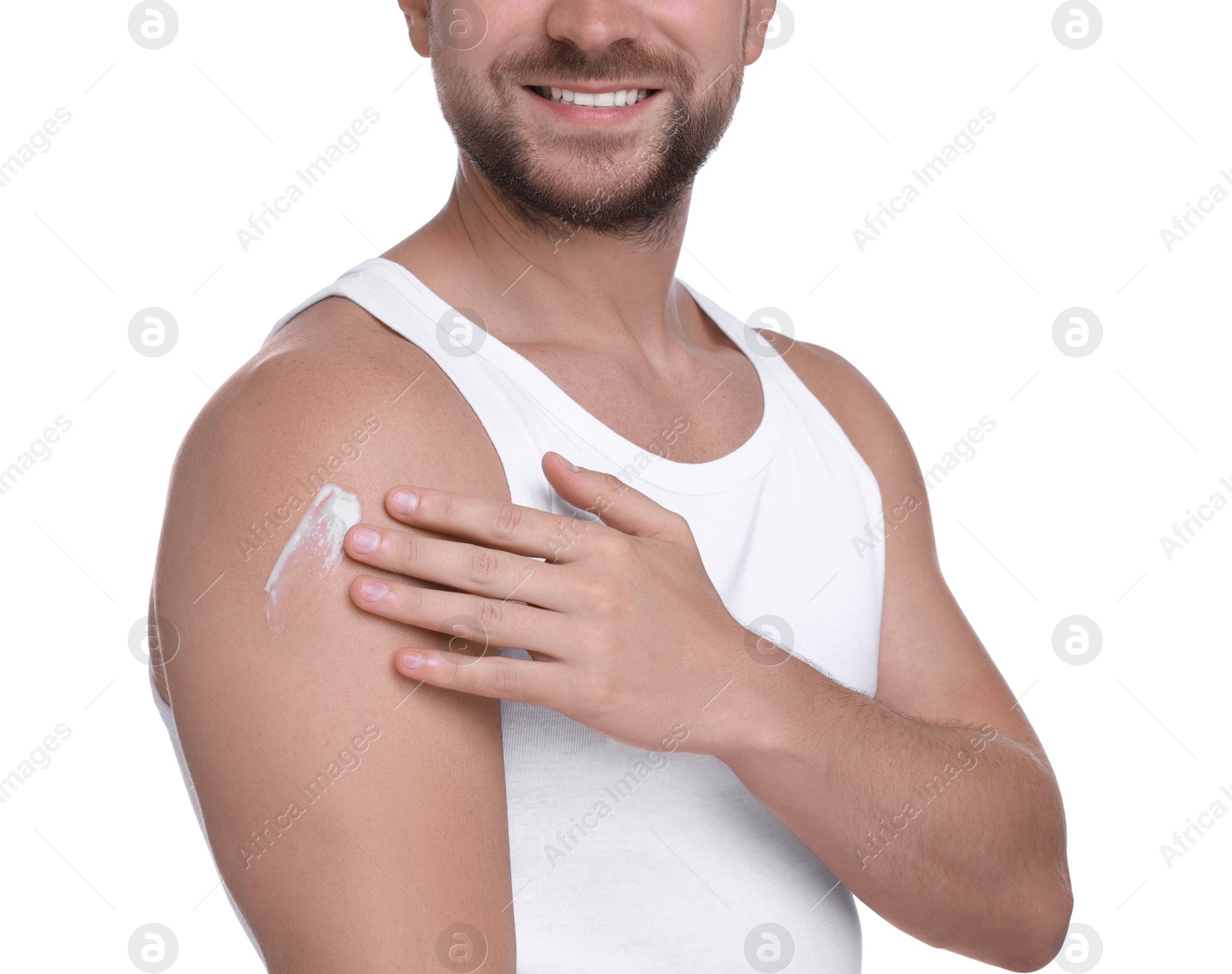 Photo of Man applying sun protection cream onto his shoulder against white background, closeup