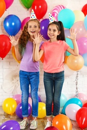 Photo of Happy children near bright balloons at birthday party indoors
