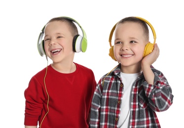 Photo of Portrait of cute twin brothers with headphones on white background