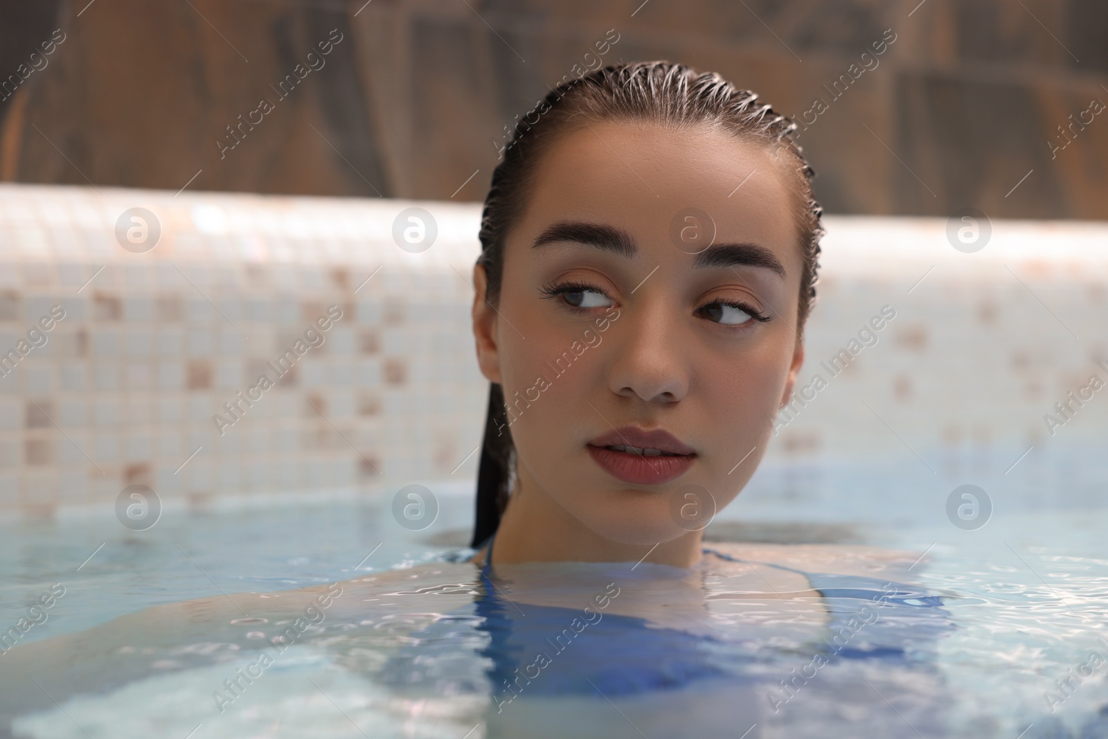 Photo of Beautiful woman relaxing in spa swimming pool