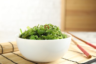 Photo of Japanese seaweed salad served on table, closeup