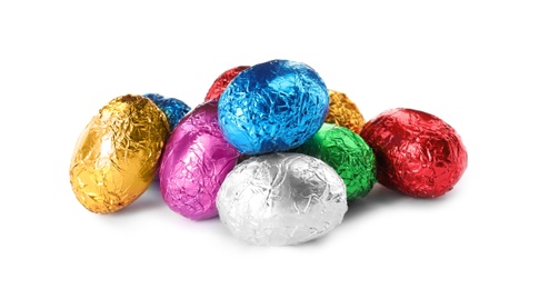 Chocolate eggs wrapped in colorful foil on white background