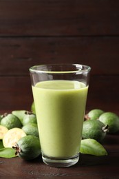 Photo of Fresh feijoa smoothie and fresh fruits on wooden table