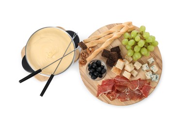 Photo of Fondue with tasty melted cheese, forks and different snacks isolated on white, top view