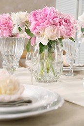 Photo of Stylish table setting with beautiful peonies indoors