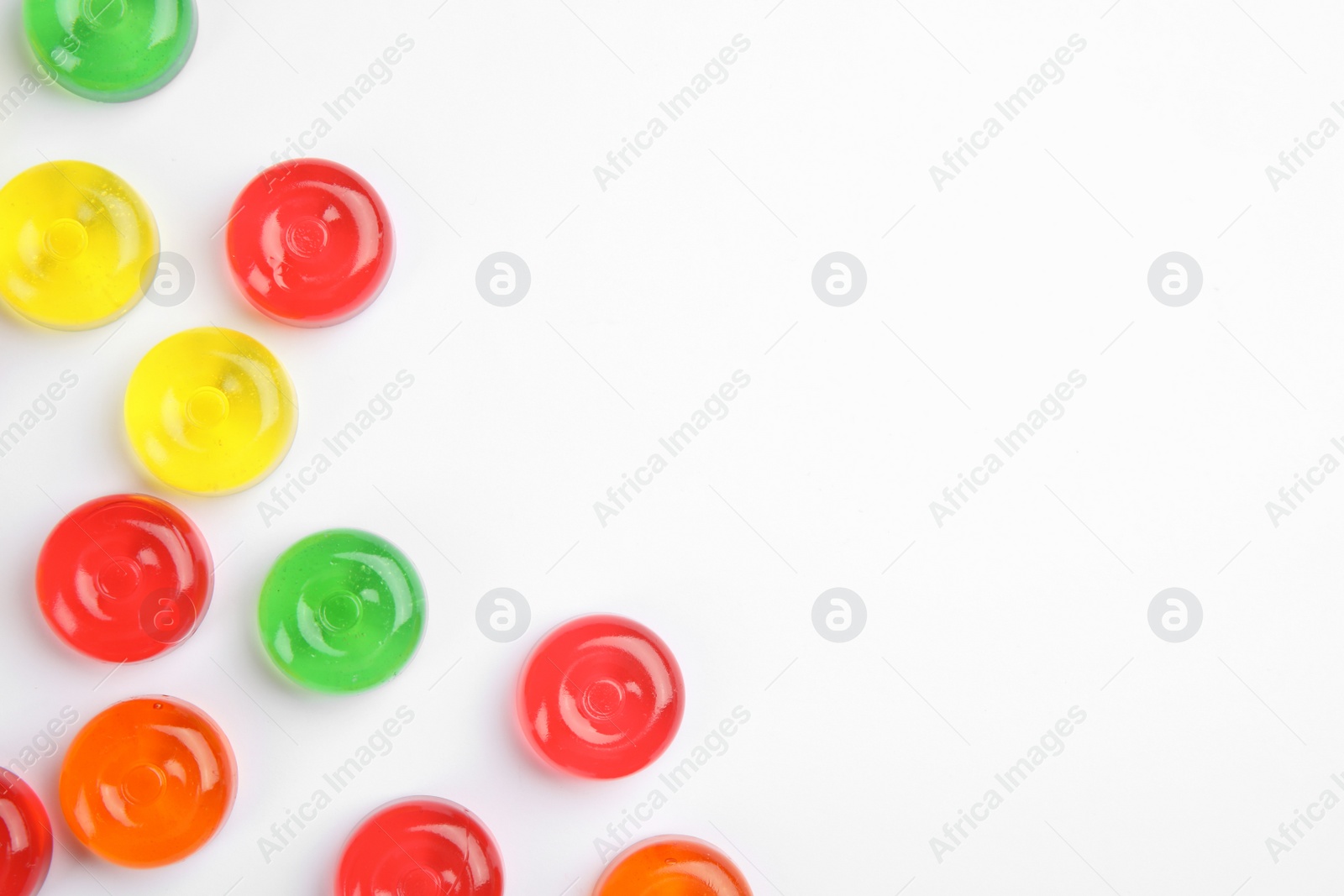 Photo of Delicious colorful candies on white background, top view