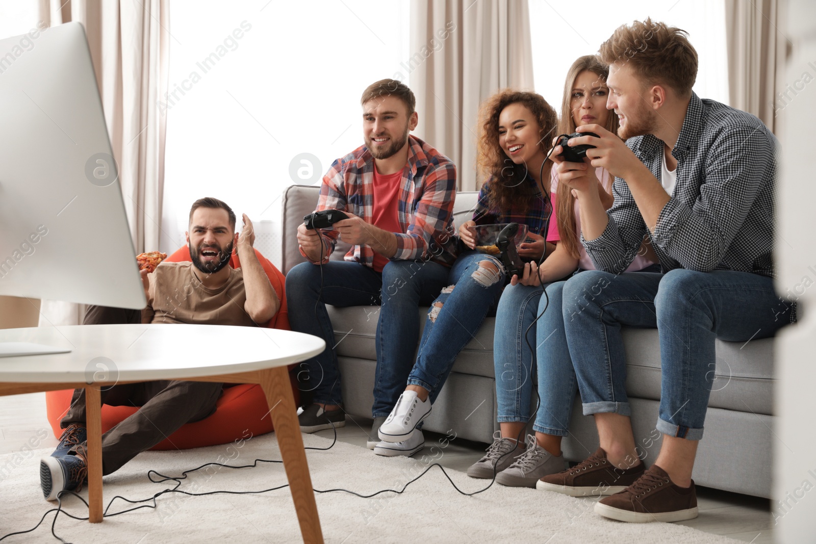 Photo of Emotional friends playing video games at home