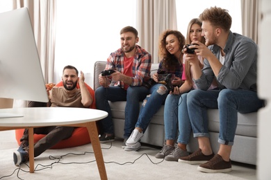 Emotional friends playing video games at home