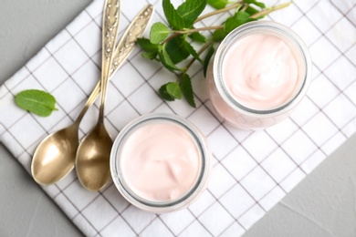 Jars with yummy yogurt on table