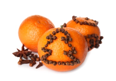 Pomander balls and tangerine with spices on white background