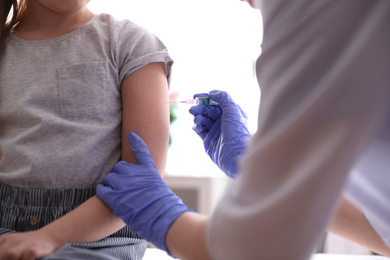 Little girl receiving chickenpox vaccination in clinic, closeup. Varicella virus prevention