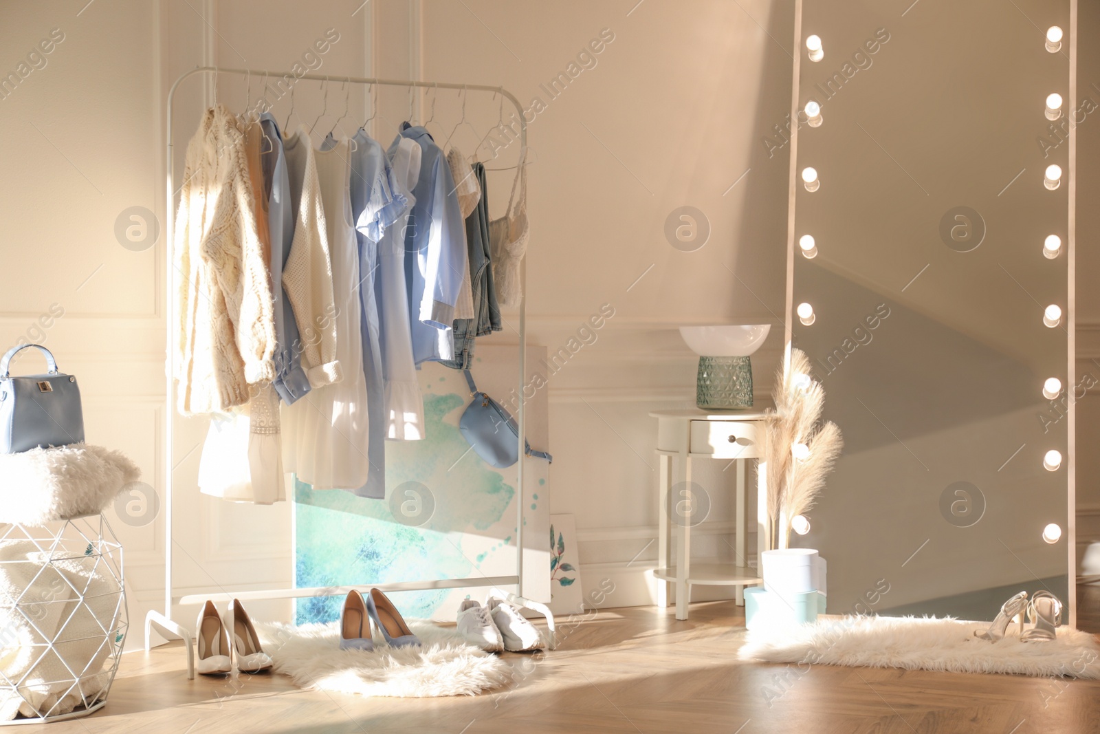 Photo of Dressing room interior with clothing rack and mirror