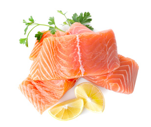 Photo of Fresh raw salmon with parsley and lemon on white background, top view. Fish delicacy