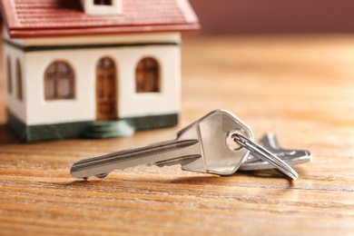 Keys on wooden table. Real estate agent services