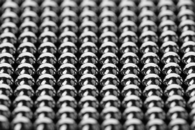 Photo of Small metal magnetic balls as background, closeup