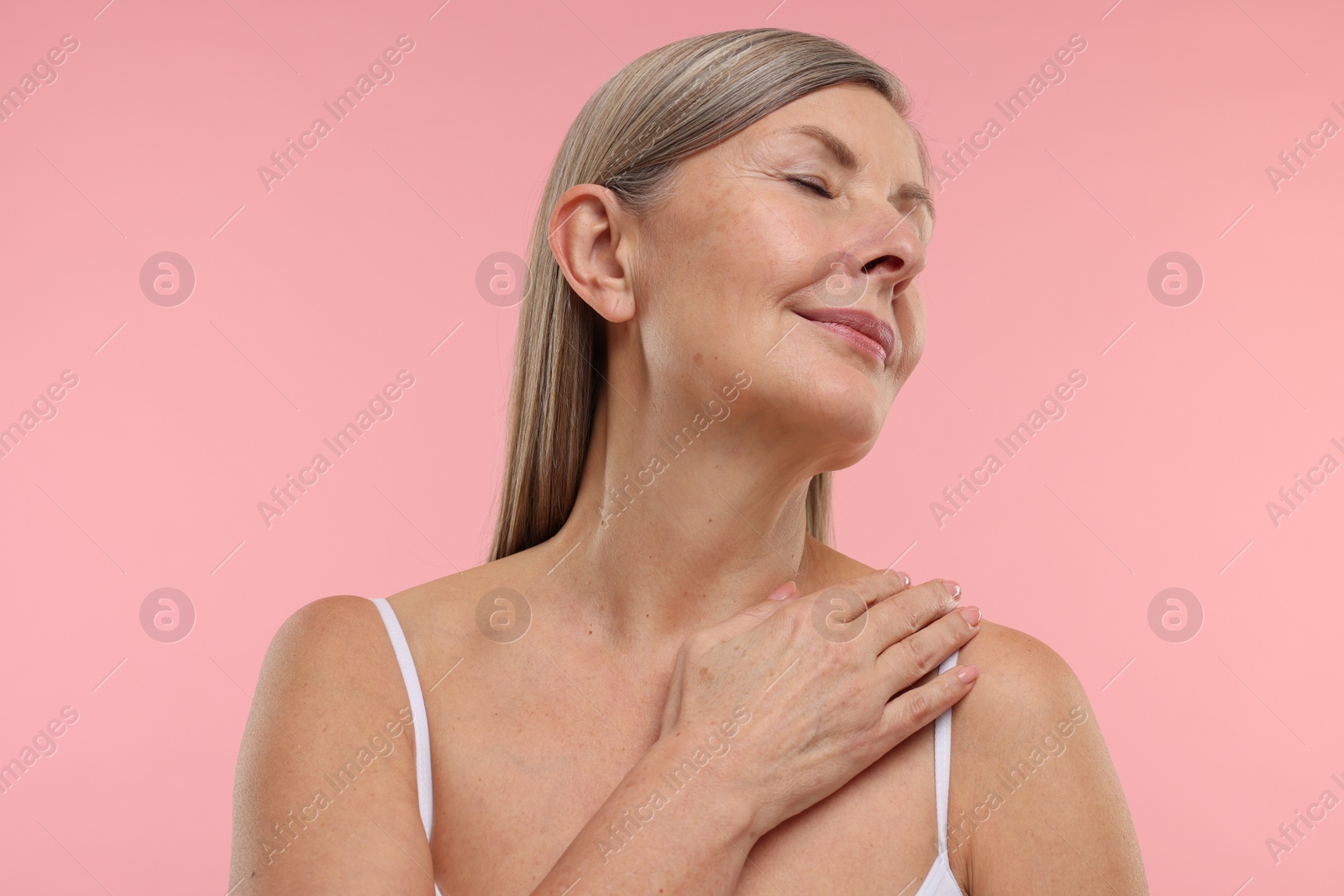 Photo of Beautiful woman with healthy skin on pink background