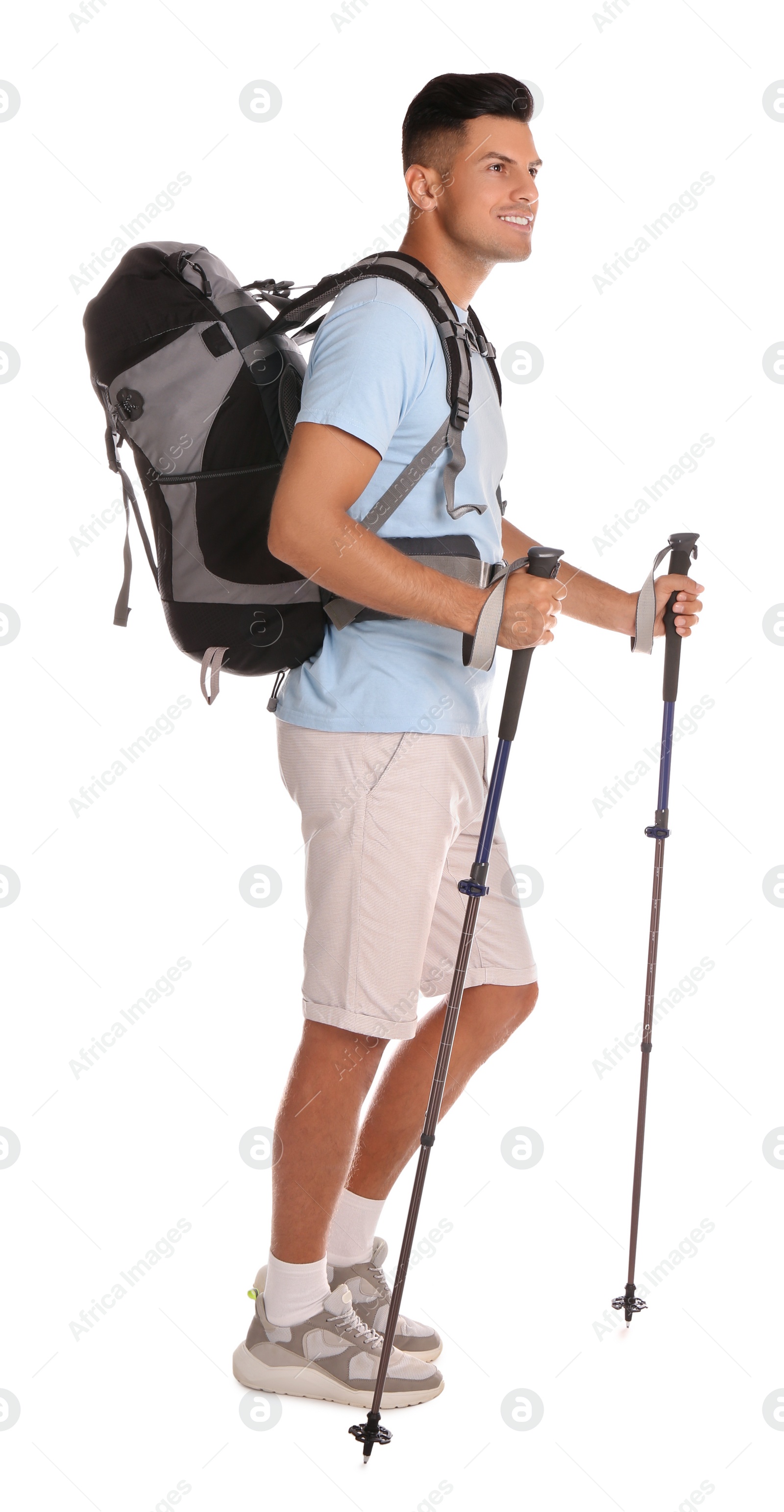 Photo of Male hiker with backpack and trekking poles on white background