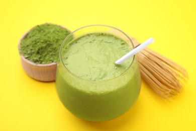 Glass of tasty matcha smoothie on yellow background, closeup