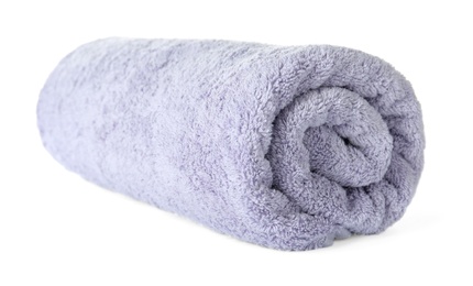 Photo of Rolled clean lilac towel on white background