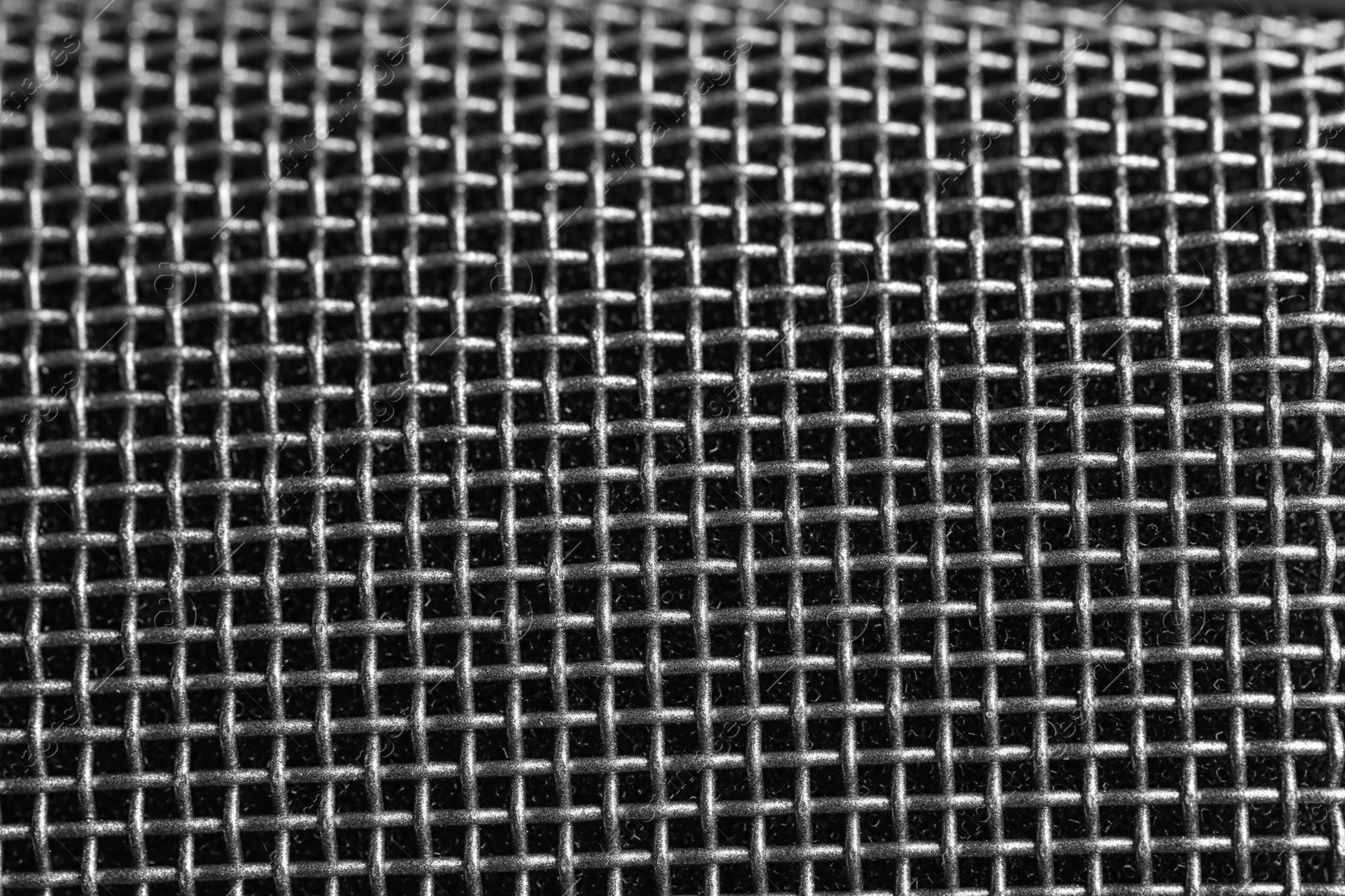 Photo of Metal mesh of microphone as background, closeup. Musical equipment