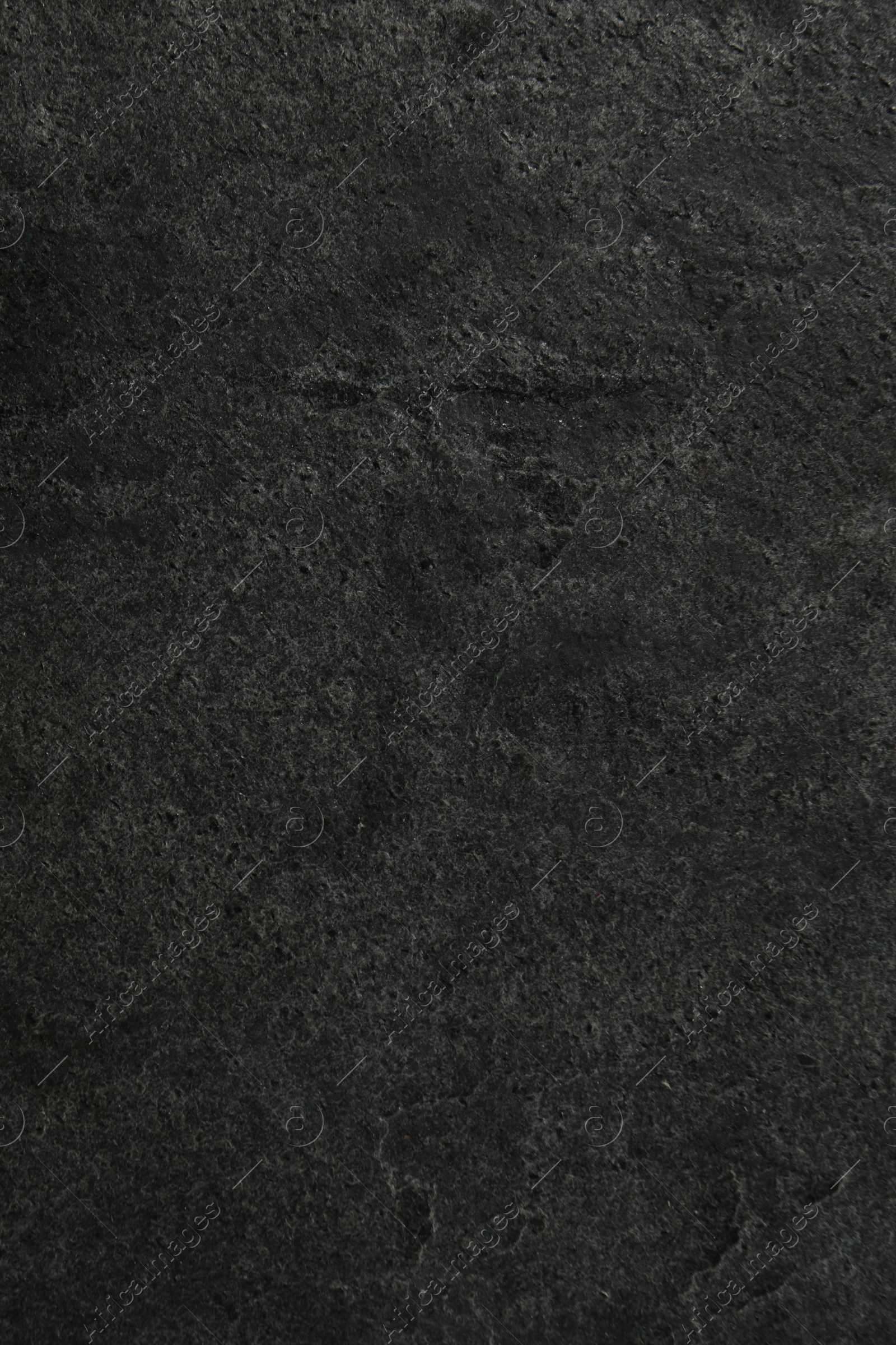 Photo of Texture of dark grey stone surface as background, closeup