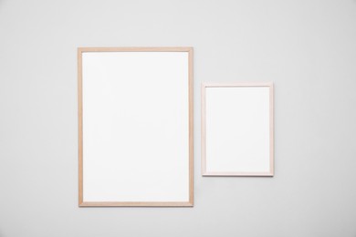 Empty frames on grey wall. Mockup for design