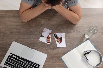 Photo of Crying man with parts of photo sitting at table indoors, above view. Divorce concept