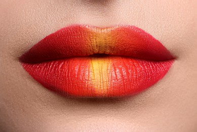 Photo of Young woman with beautiful lips makeup, closeup