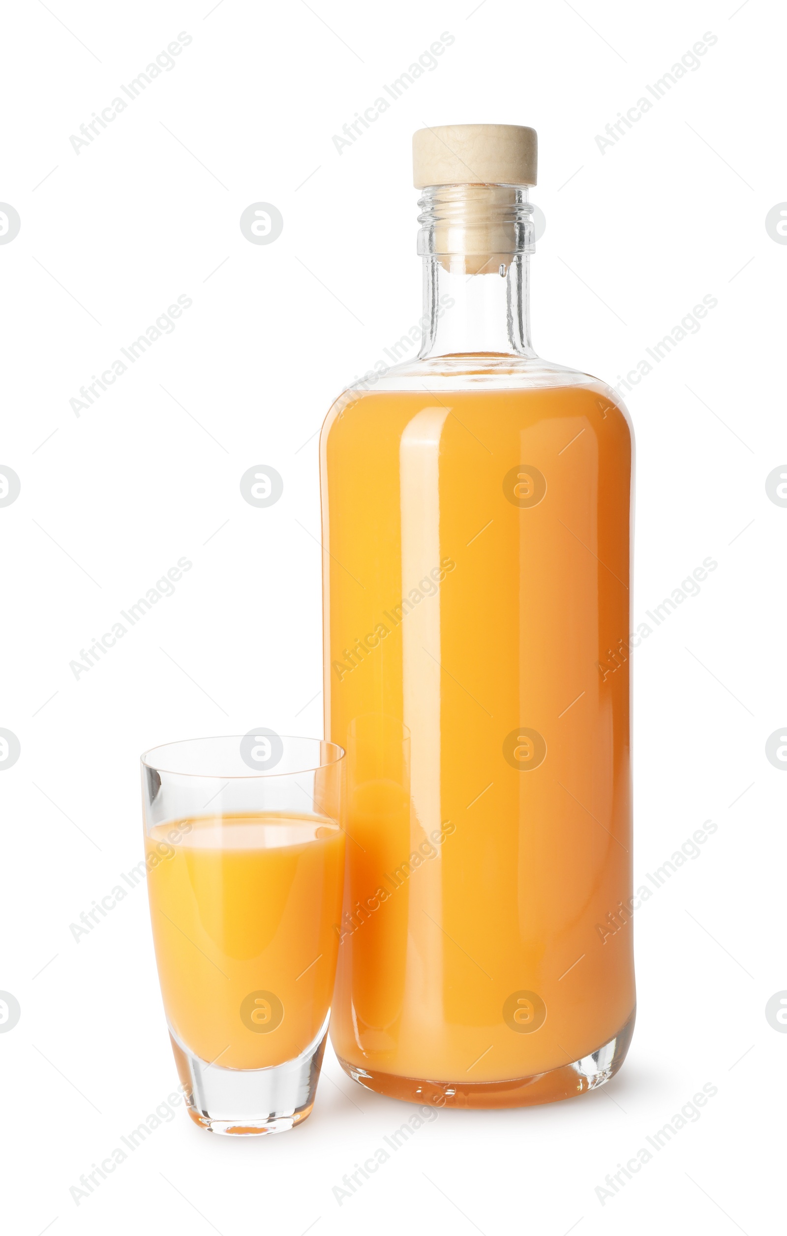 Photo of Bottle and shot glass with tasty tangerine liqueur isolated on white