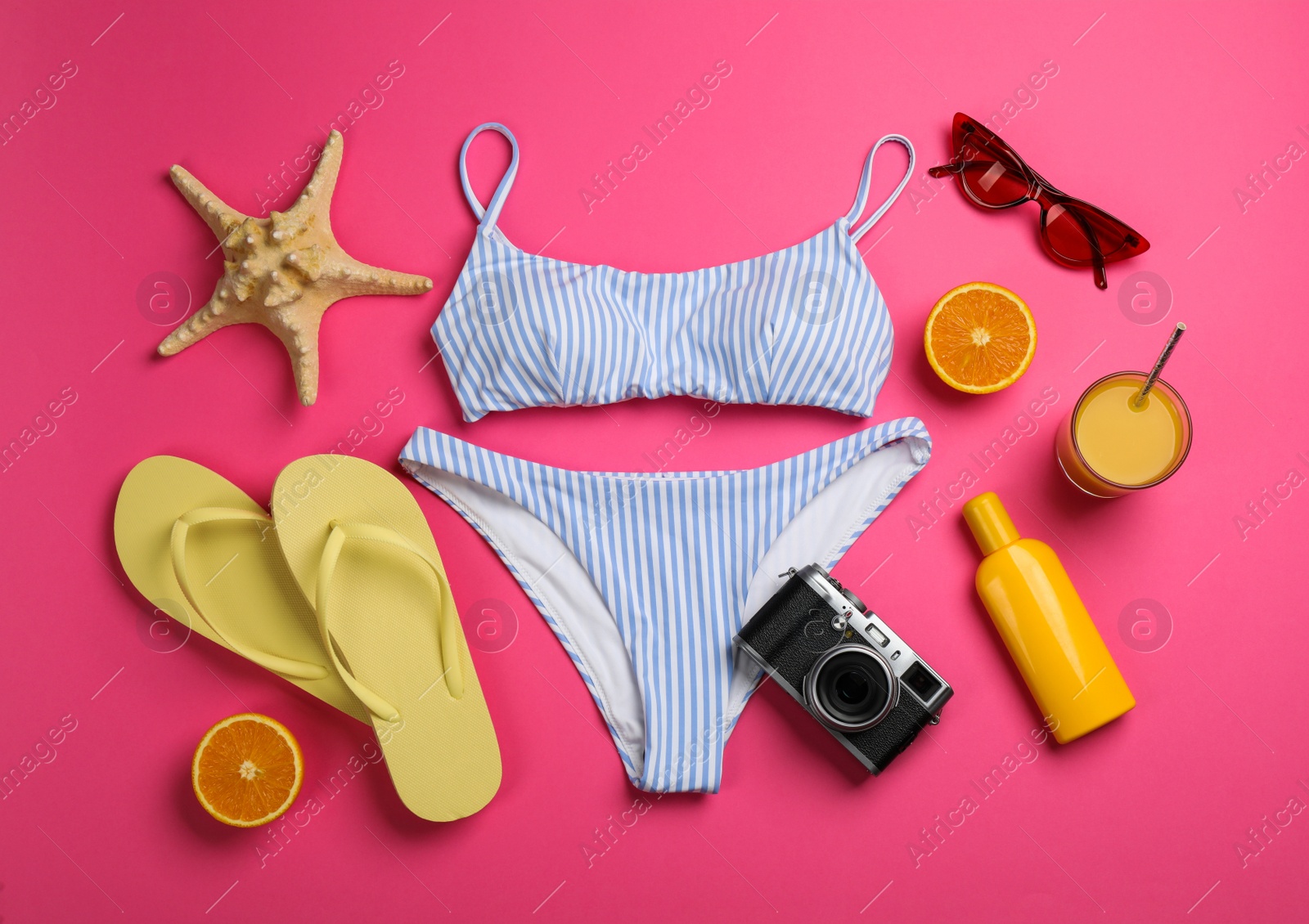 Photo of Flat lay composition with beach objects on pink background