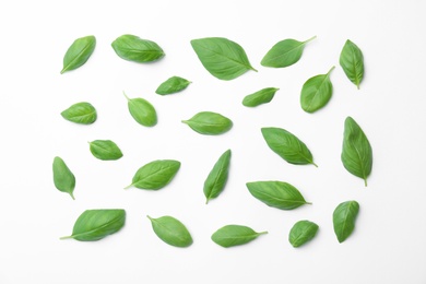 Photo of Fresh green basil leaves on white background, top view