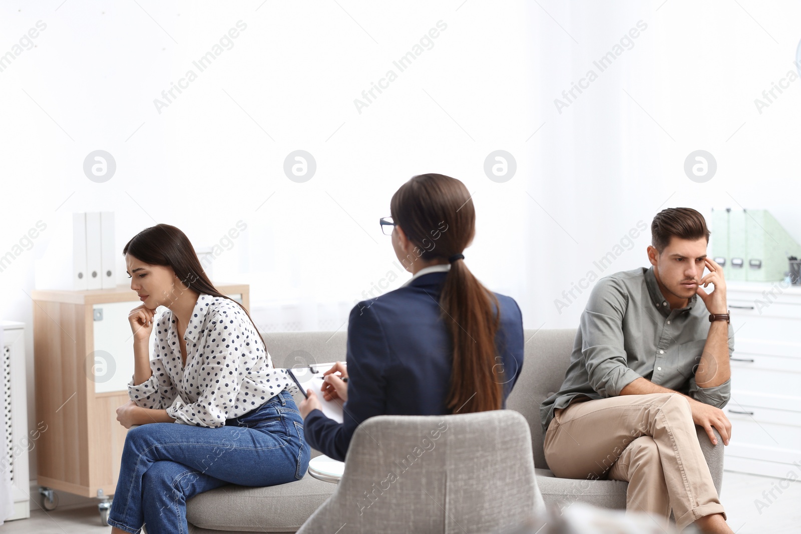 Photo of Professional psychologist working with couple in office