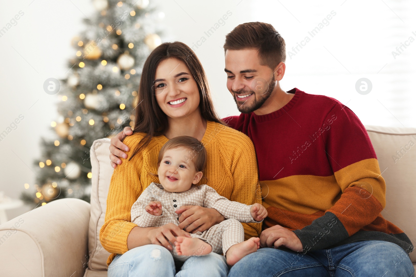 Photo of Happy family with cute baby at home. Christmas celebration