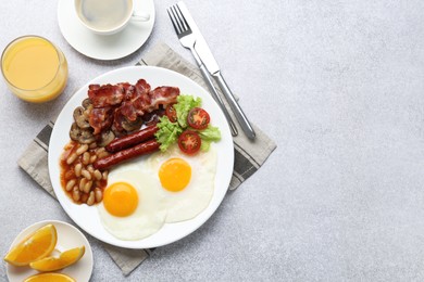 Delicious breakfast with sunny side up eggs on light table, flat lay. Space for text