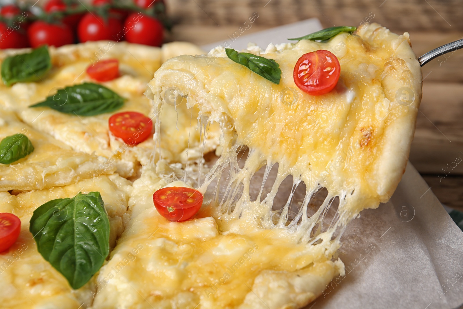 Photo of Taking tasty homemade pizza slice with melted cheese, closeup