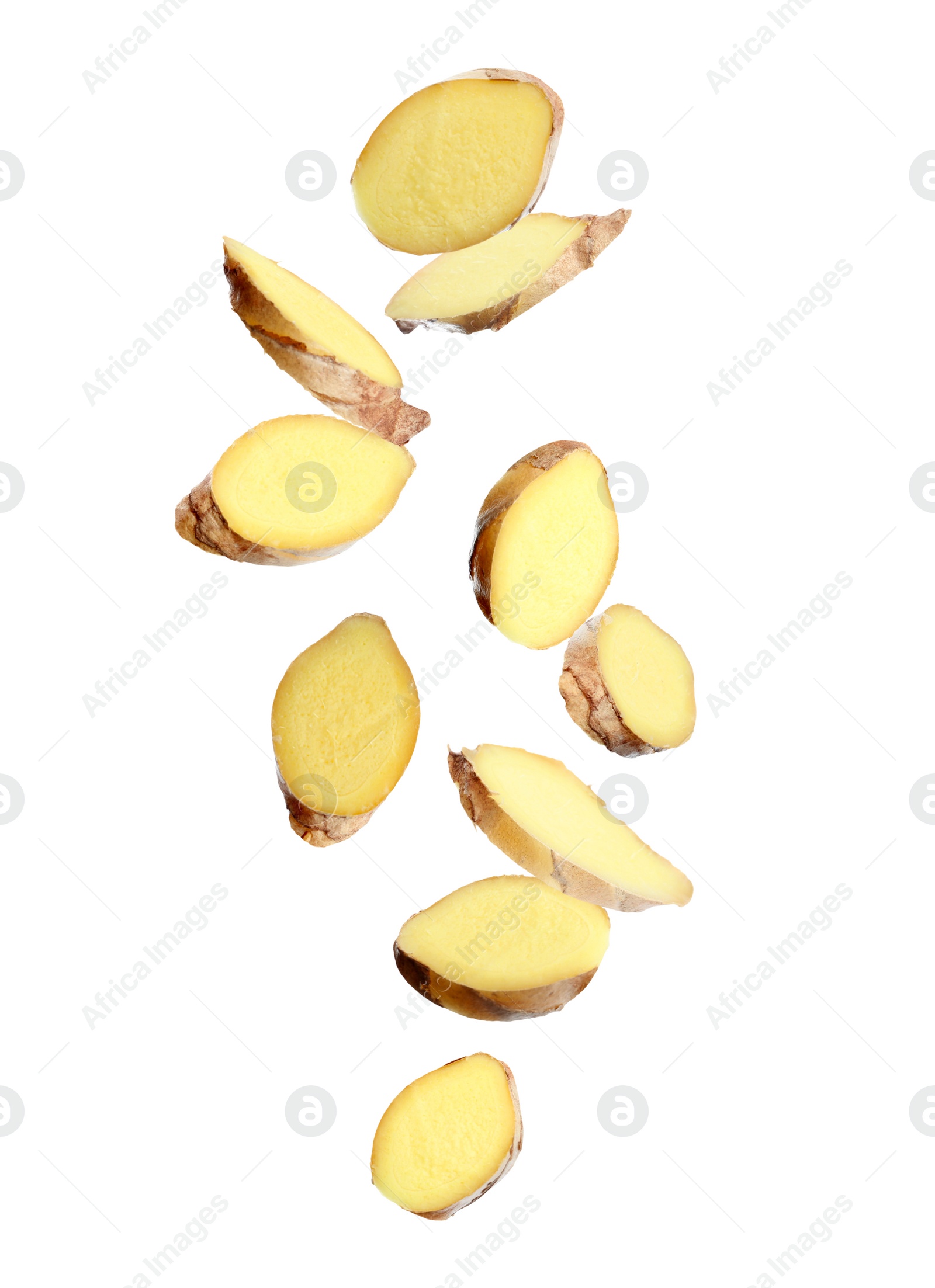 Image of Fresh sliced ginger falling on white background