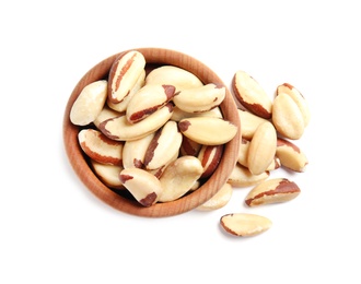 Wooden bowl with Brazil nuts on white background, top view