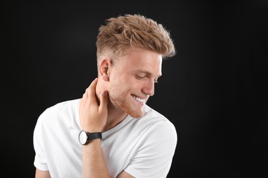 Portrait of handsome young man on black background